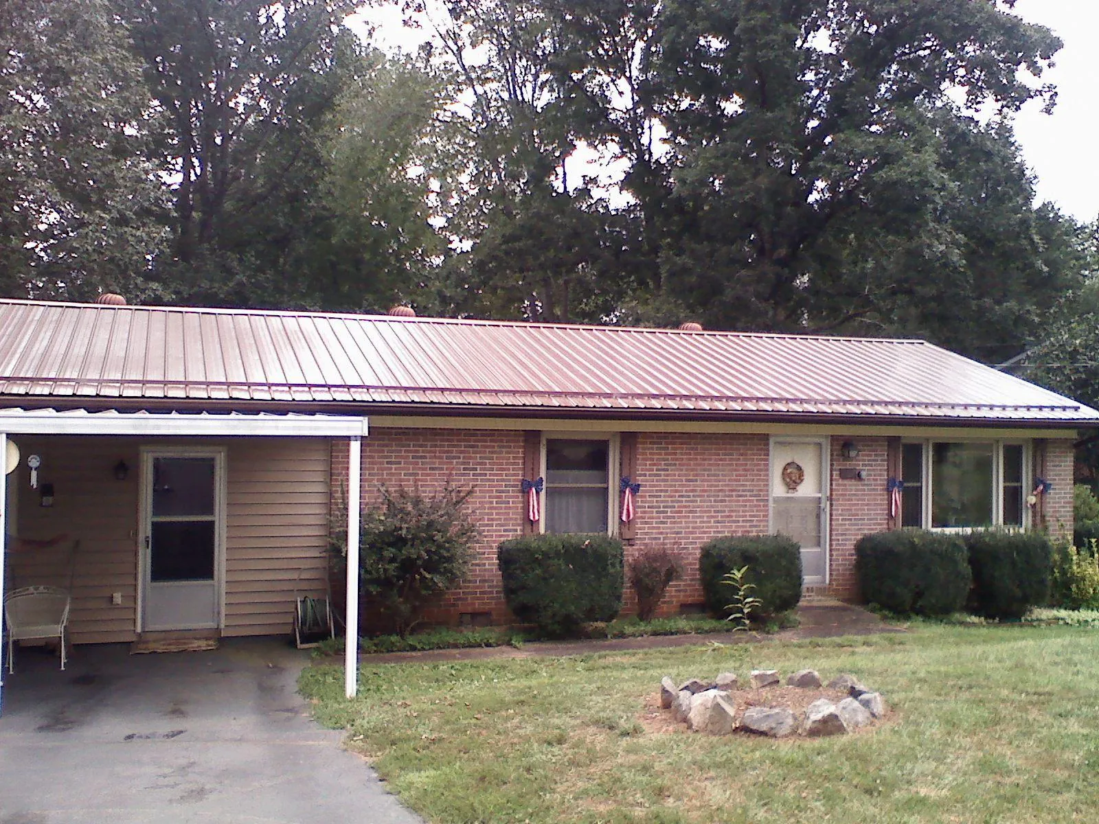 Bronze metal roof and carport on a brick ranch home — Roof Repair work by our crew in Silver Lake